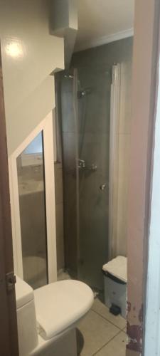 a bathroom with a toilet and a glass shower at Hotel y Cabañas La Magia del Sur in Valdivia