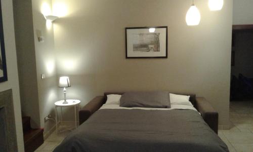 a bedroom with a bed and a picture on the wall at casa vacanze crochi in Viterbo