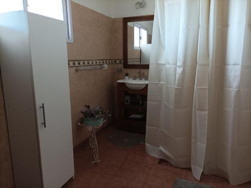 a bathroom with a sink and a shower curtain at Casa en Ataliva Roca in Ataliva Roca