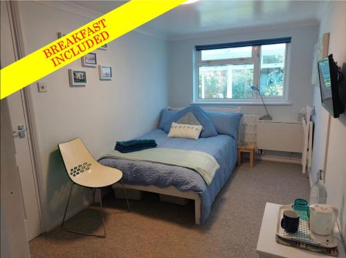 a bedroom with a blue bed and a yellow caution sign at Double bedroom with ensuite wet room, incl breakfast, in Woking in Woking