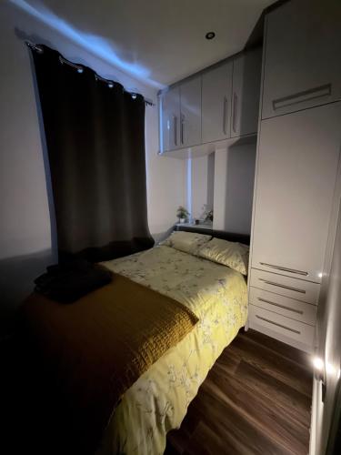 a bedroom with a bed in a dark room at Harvey Apartments in Derry Londonderry