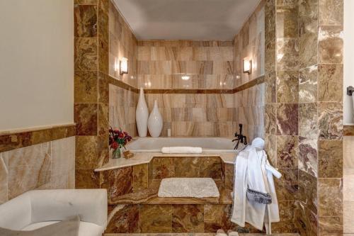 a bathroom with a tub and a sink at Abode at Open Meadows in Wilson