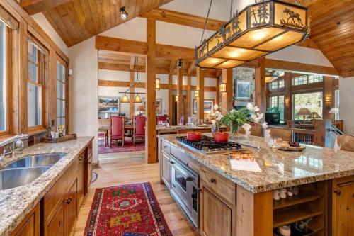 a kitchen with a large island with a stove at Abode at Two Wolves in Teton Village