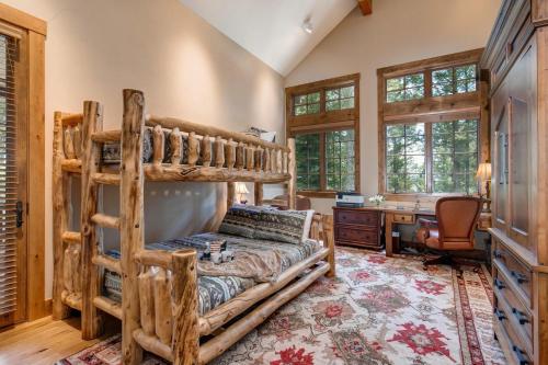 a bedroom with a bunk bed and a desk at Abode at Two Wolves in Teton Village