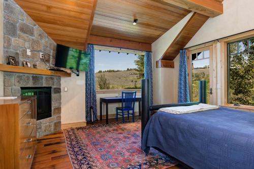 a bedroom with a bed and a fireplace at Abode at Skyline in Jackson