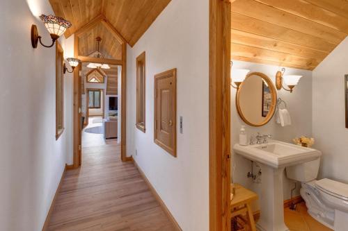 a bathroom with a sink and a mirror at Abode at Golden Spruce in Wilson