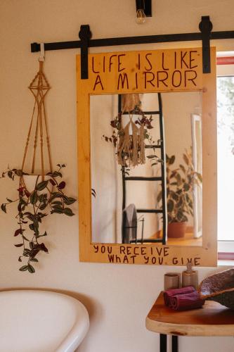 a mirror hanging on a wall above a bathroom sink at Herdade da Maceira in São Luis