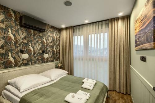 a bedroom with a bed with two towels on it at Cicho Sza in Tylicz