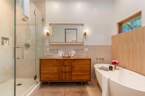a bathroom with a tub and a sink and a mirror at Abode at Alpenglow in Wilson
