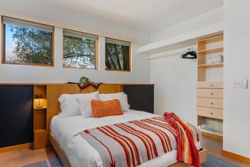 a bedroom with a bed and some windows at Abode at Alpenglow in Wilson