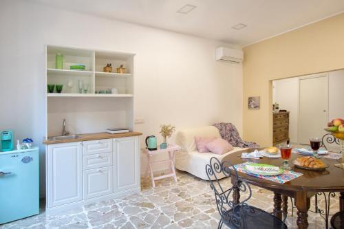 a kitchen and a living room with a table at Plaza Suites in Piazza Armerina