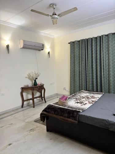 a bedroom with a bed and a ceiling fan at Sparra Homes in Gurgaon