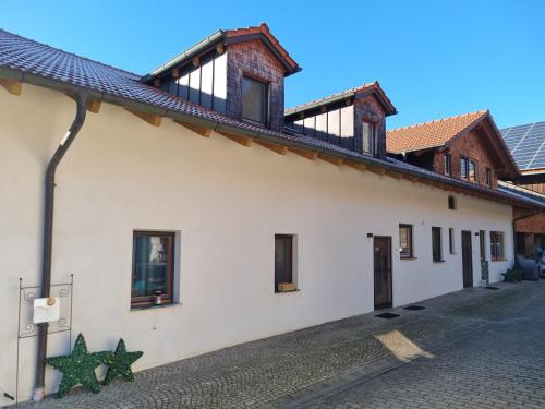 a white building with a star on the side of it at Chalet Hoamad im Bayerischen Wald in Eschlkam