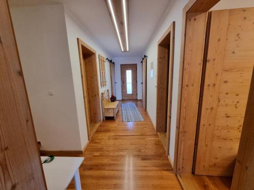 a hallway of an apartment with wooden floors and doors at Chalet Hoamad im Bayerischen Wald in Eschlkam