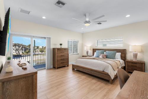 a bedroom with a bed with a ceiling fan at Beach Nuts by Sun Palace Vacations in Fort Myers Beach