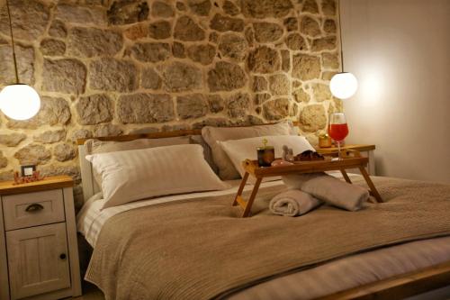 a bedroom with a bed with a table on it at Cliffside Villa Vilić in Vrgorac