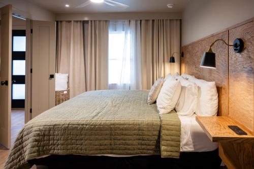 a bedroom with a large bed with white pillows at Gloria Inn - Unit 8 in Waco