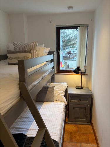 a small bedroom with two beds and a window at The Glebe in Fort William