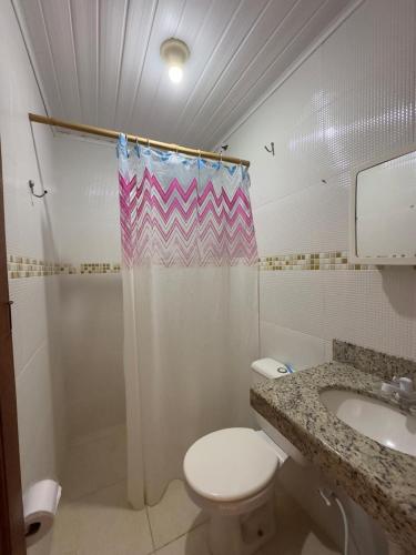 a bathroom with a toilet and a shower and a sink at HOSTEL NATIVOS in Linhares