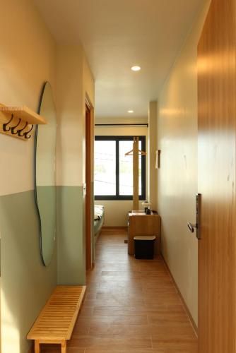 a hallway with a bathroom with a sink and a bench at Hale Homestay in Ấp Thanh Sơn (1)