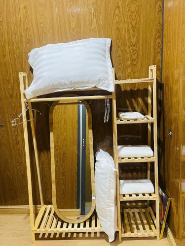 a bunk bed in a room with two shelves at Farm Tân Tiến in Ấp Bình Thạnh