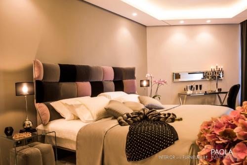 a bedroom with a large bed with a black headboard at Royal Tulip Achrafieh in Beirut