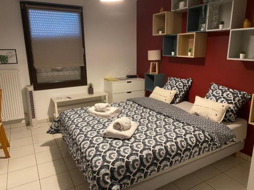 a bedroom with a bed with towels on it at La petite tuilerie d Eguisheim in Eguisheim