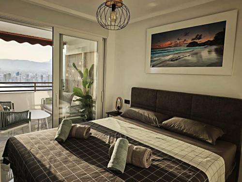 a bedroom with a bed with a view of the ocean at Sea&Skyline Suites Benidorm in Benidorm