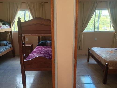 a bedroom with two bunk beds and a mirror at Vista del Lago in Villa Carlos Paz