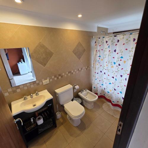 a bathroom with a sink and a toilet and a mirror at Merlo Trail Lodge in Merlo