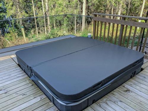 a bed sitting on top of a wooden deck at Holiday Home Klippan by Interhome in Tuuhonen