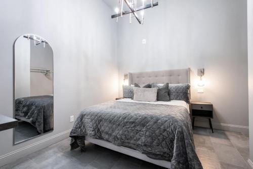 a bedroom with a large bed and a mirror at Hollyhock Suite 403 in Louisville