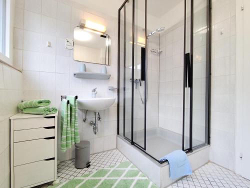 a bathroom with a shower and a sink at Ferienhaus Iris in Radolfzell am Bodensee