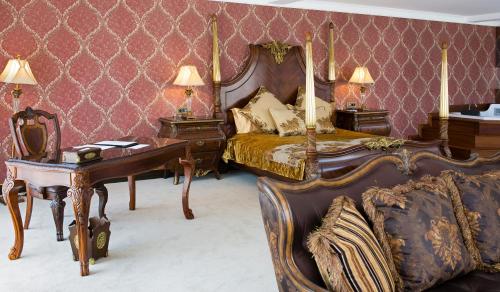 a bedroom with a bed and a table and a desk at Svalinn Hotel in Izmir