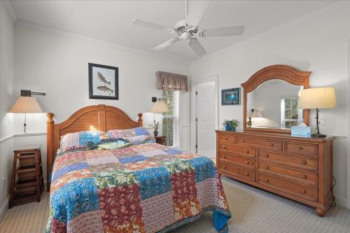 a bedroom with a bed and a dresser and a mirror at River Watcher Cottage in Bell