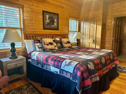 a bedroom with a bed in a log cabin at Blushing Bear Stunning Views in Sevierville