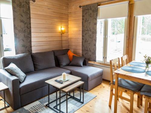 a living room with a couch and a table at Holiday Home Yllästokka 5 by Interhome in Ylläsjärvi
