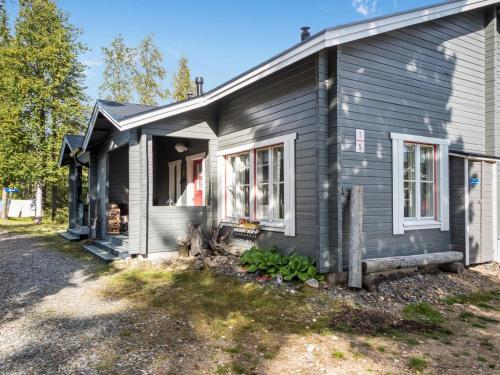 a gray house with a window on the side of it at Holiday Home Yllästokka 5 by Interhome in Ylläsjärvi