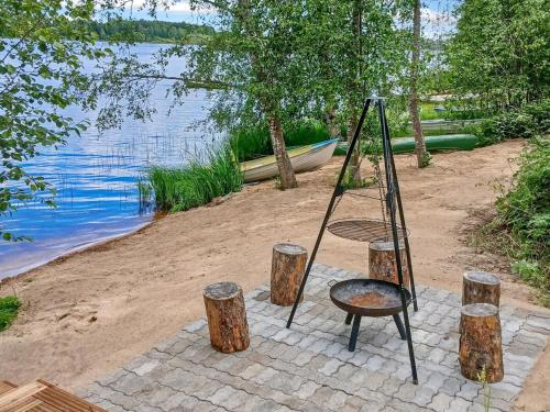 a ladder and some logs and a bench and water at Holiday Home Salmiranta by Interhome in Jämijärvi