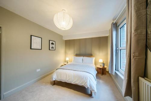 a bedroom with a bed and a large window at Spacious 2-Bed House with Garden Office in Oxford
