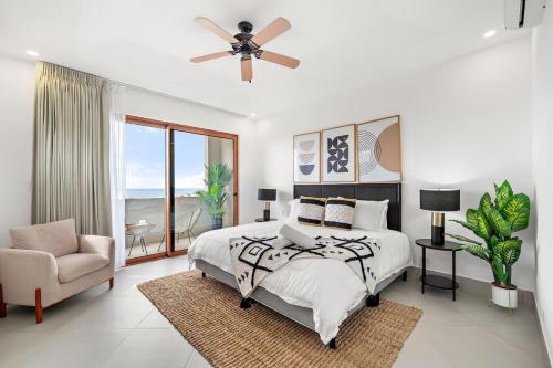 a bedroom with a bed and a ceiling fan at Panaromic Oceanview Luxury 3BR Private Rooftop in Tamarindo