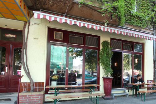 a restaurant with benches in front of a building at Die Fabrik - Hostel in Berlin