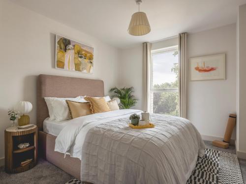 a bedroom with a large bed and a window at Charles Hope Cambridge in Cambridge