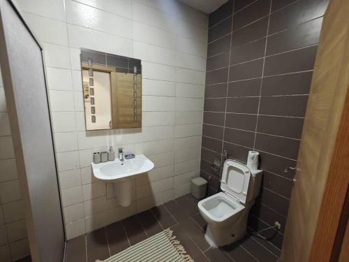 a bathroom with a toilet and a sink at Bark luxury apartments Abidjan Attoban 2 in Abidjan