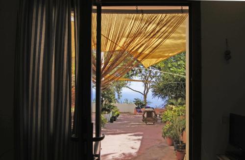 an open door with a view of a patio at Villa Alba Appartamenti in Kamma