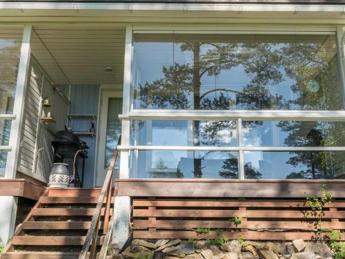 a reflection of a tree in the window of a house at Holiday Home Rantalinna 2 by Interhome in Ruokolahti