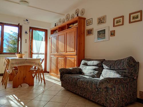 a living room with a couch and a table at Casa Lory in Prato Nevoso