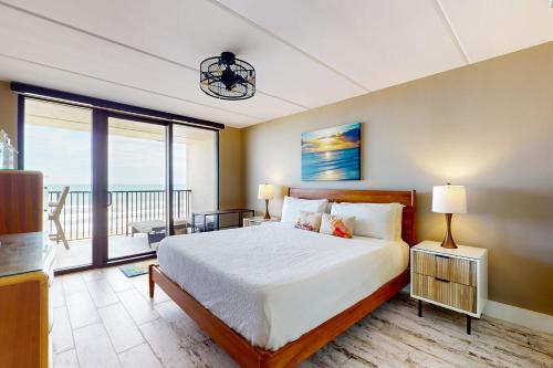 a bedroom with a large bed and a balcony at Updated 3BR w/ Gulf Views: Suntide III - Unit 801 in South Padre Island