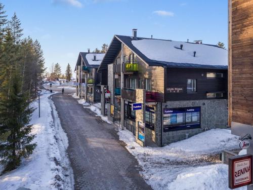 a row of parking meters in the snow next to a building at Holiday Home Levin stara a03 by Interhome in Levi