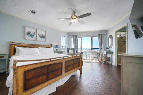 a bedroom with a bed and a ceiling fan at Family Tides - Beachfront Pet-Friendly Duplex in Destin